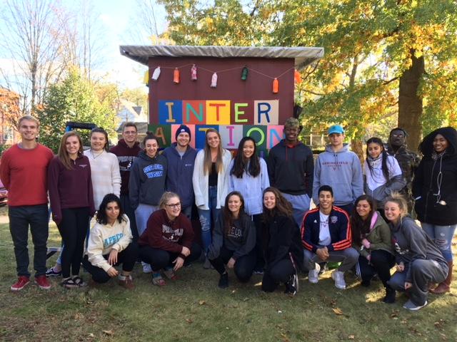 Springfield College art students in front of habitat they help build.