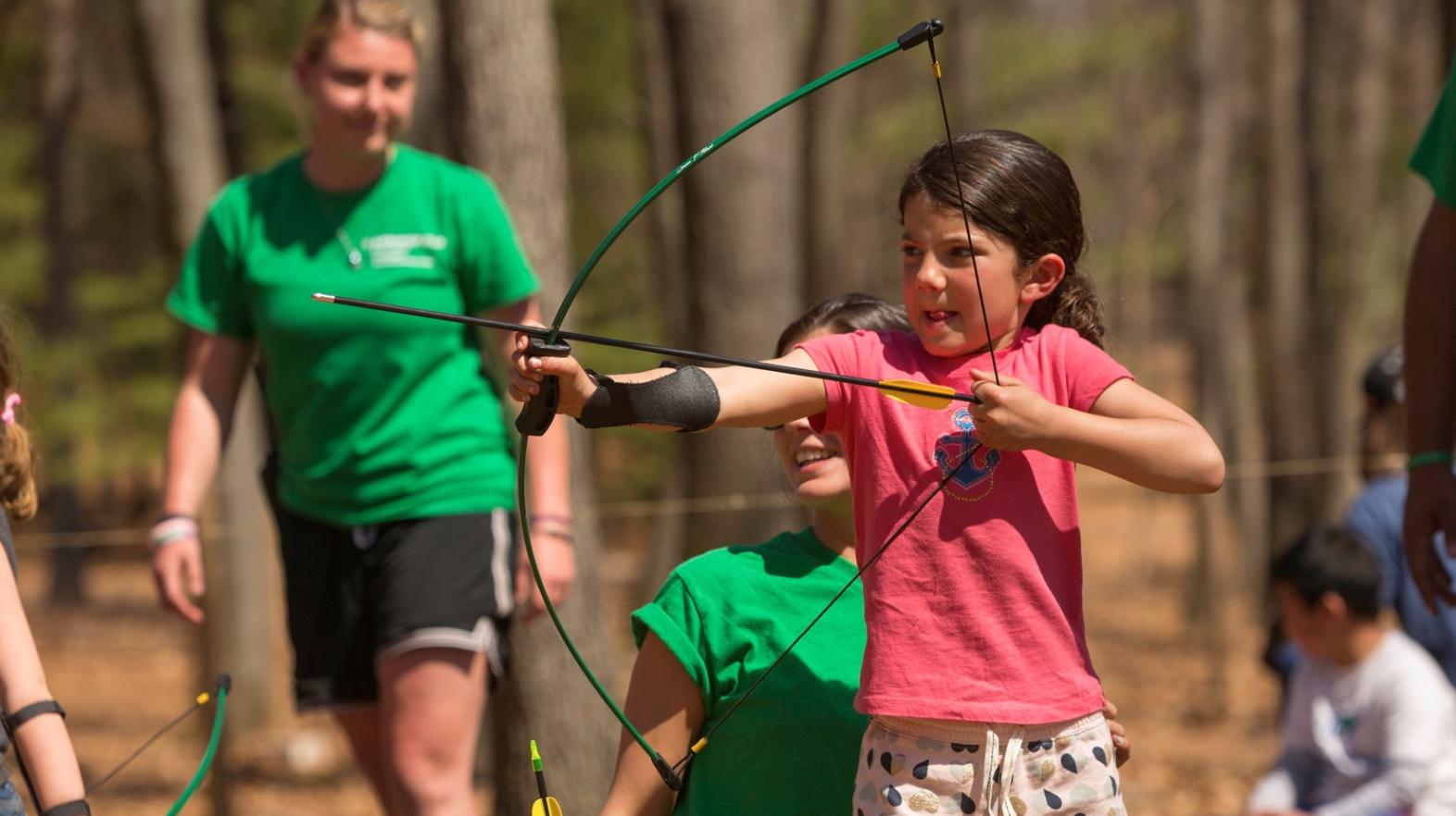 Child exploring archery at Spring Explorers at East Campus
