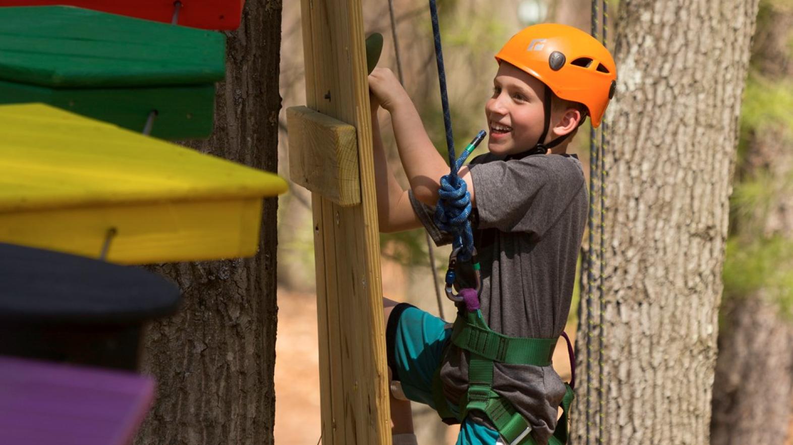 Student on challenge course at East Campus
